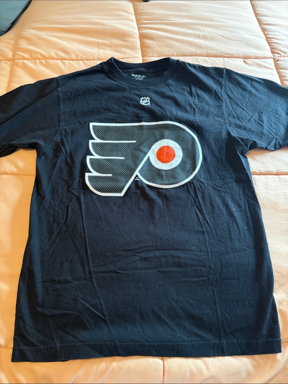 NHL Black T-shirt with White Printed Label and Orange Background Accent